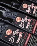 Macro view of black 2 oz Mornin' Sizzle Bacon Bitz coffee pouches