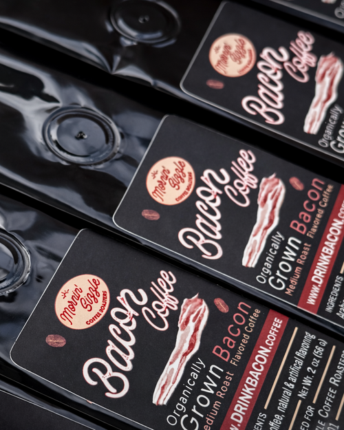 Macro view of black 2 oz Mornin' Sizzle Bacon Bitz coffee pouches